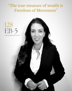 Selina Jayne Weaver, founder of 128 EB-5, standing in a black suit with pearl necklace beside the 128 EB-5 logo and the quote “The true measure of wealth is Freedom of Movement.”