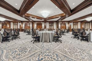The 4,664-square-foot Forest Ballroom features soft tones of gold and cream, grand wooden beams, scrolled millwork, and new chandeliers that illuminate muted blue and taupe carpets.
