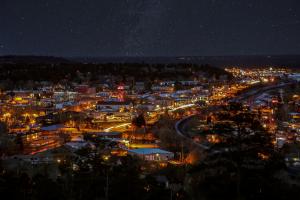 Lights from the city of Flagstaff can be seen beneath a star-filled night sky.