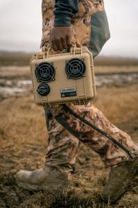 Image of a hunter dressed in camo and carrying a DemerBox DB2 Speaker