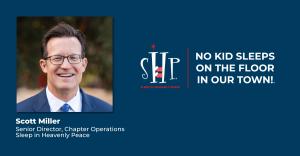 Professional headshot of Scott Miller, a man with dark hair and glasses wearing a navy suit and blue tie, smiling at the camera. The Sleep in Heavenly Peace logo and tagline "NO KID SLEEPS ON THE FLOOR IN OUR TOWN!" appear on a dark blue background to the
