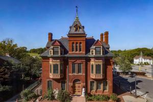 7-bedroom, 4.5-bath Victorian residence sits on a .27± acre lot and includes a detached 1BR/1BA guest cottage/office, a detached pool house with garage/carriage house, and a beautiful courtyard with an in-ground saltwater pool.