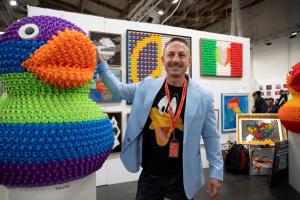 Artist Facundo Yebne, also known as FLY, standing beside his installation Light and Darkness at the Florence Biennale, where he received the Installation Art Fourth Prize.