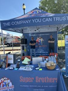 Super Brothers Plumbing Heating & Air outreach booth at a Sacramento-area community event featuring HVAC, plumbing, and rebate information.