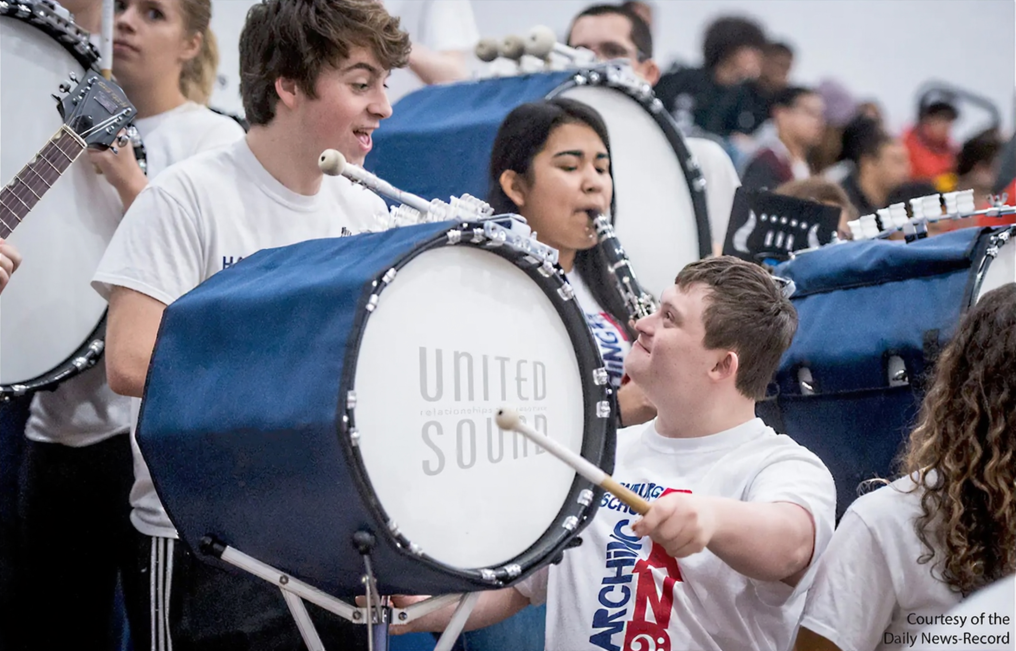 The United Sound student is encouraged by his mentor to play the base drum.