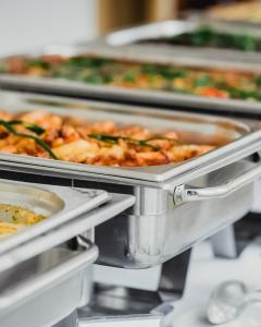 Close-up foodservice trays filled with clean-label meals prepared for cafeterias and hot bar service.