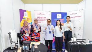 Group photo of Robotimize Group and Hasba Medik team members standing together at Hasba Medik exhibition booth