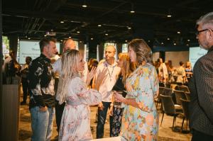 Rachel and Shane Krider chatting with attendees at a previous Prosperity Of Life event.