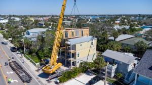 Two-Site Construction Set Day with Crane Placing Living Space Section onto Elevated Foundation