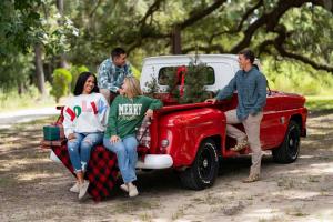 Kids in Palmetto Moon clothes sitting in a holiday truck