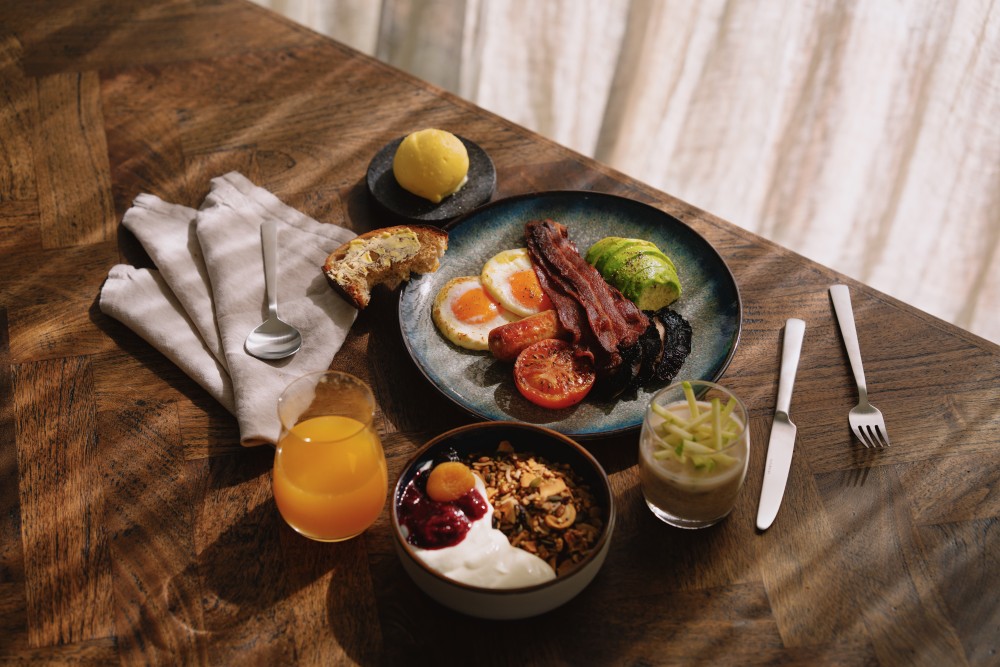 A plated dish at Domu Retreat featuring locally sourced New Zealand produce — artfully arranged on stoneware with natural textures and tones, representing Toby Stuart’s philosophy of simplicity, locality, and connection through food.
