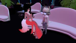 Two avatars sitting in a modern virtual lounge — one in a red evening gown with black hair, the other wearing glasses and a tie — inside the Ferry Godmother Roller Rink’s VR event venue designed for inclusive social experiences.