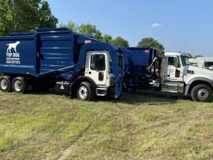 Fleet of Top Dog Waste Solutions trucks lined up and ready to begin commercial waste collection.