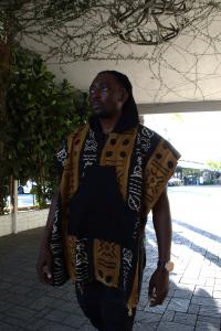 Actor and founder of Bogolonfini, Bambadjan Bamba, wears a custom-made piece from his eco-friendly fashion line celebrating heritage, craftsmanship, and cultural pride