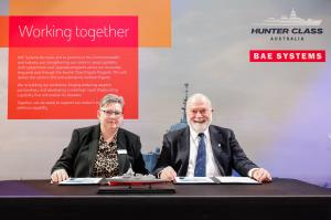 Picture of two people, a man and a woman, sat at a desk