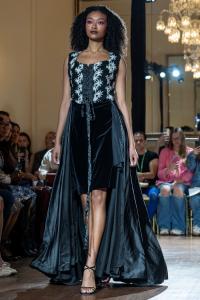 A model wears a black gown on the New York Fashion Week runway