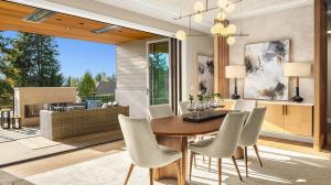 Luxury dining room and outdoor living area by Ariana Designs & Interiors, featuring wood accents, soft neutral tones, and seamless indoor-outdoor flow.