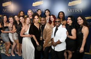 Dr. Carl Truesdale, his wife and co-founder Juliana Truesdale, and the team standing together on the red carpet before an Artisa backdrop, smiling and dressed in elegant evening attire at the Los Angeles launch event.