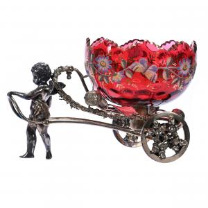 Magnificent Victorian figural brides basket with a cranberry art glass bowl decorated with coralene butterfly and floral décor with gold stencil highlights. Estimate: $1,500-$3,000.