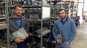 Alexander and Mike, co-founders of OceanTech, standing in their warehouse and surrounded by retired IT equipment ready for re-reuse.