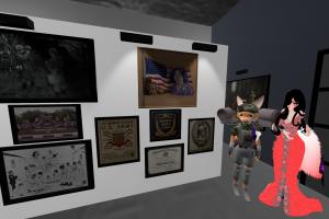 A 3D virtual gallery scene showing framed photographs and plaques honoring U.S. Army veterans and the Women’s Army Corps. Two avatars — a fox-like soldier figure with multiple oversized cameras and an elegant Ferry Godmother character in a red gown — stan