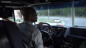 Dr. Anton Anthony, Superintendent of Hancock County Schools, driving a yellow school bus early in the morning to help cover transportation needs.