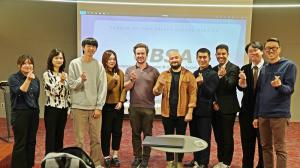 Media representatives and company speakers at the Global Media Meet-Up pose for a group photo after the event.