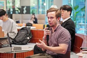 Leo Thevenet, Founder and Editor-in-Chief of Le Café du Geek, asks a question during the event.