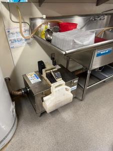 Grease interceptor installed inside a commercial kitchen in San Bernardino to prevent fats, oils, and grease from entering the sewer system.