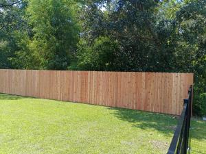Durable wood and iron fence installed by Tony’s Fencing and Iron Works in Southeast Louisiana.