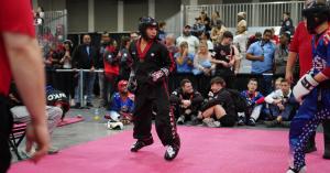 Team Canada athlete Eli Cooper is competing in point fighting against a member of Team USA at the 2025 WKC World Championships