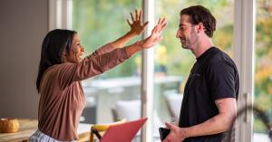 Veteran husband and wife celebrating together at home after working with REE Medical, representing the positive outcome of receiving medical evidence support for VA disability claims.