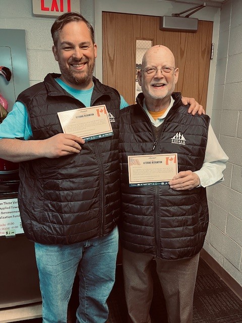 Durham School Services team members David and Kurtis from West Bloomfield, MI, wearing their veteran vests.