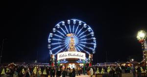 Guests enter the Cullman Christkindlmarkt under the Christmas Pyramid and Ferris Wheel