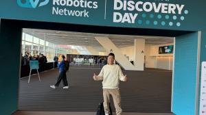 Zen Koh standing at entrance to Robotics and AI Discovery Day 2025 event at David L. Lawrence Convention Center, Pittsburgh, Pennsylvania
