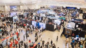 Overhead view of Robotics and AI Discovery Day 2025 exhibition floor showing attendees, company booths, and demonstrations at David L. Lawrence Convention Center, Pittsburgh