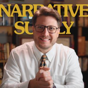 Photo of Narrative Supply Founder Adam Lambert in an office setting, nice lighting, that appears to be a screen grab from Narrative Supply's YouTube Channel. He's smiling quite big, especially with his eyes, and he's wearing a white button up shirt with a