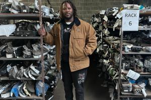 A workforce trainee organizing recycled auto parts at Select Auto Parts in Milwaukee, part of a partnership with Goodwill Industries and the Wisconsin Department of Workforce Development.