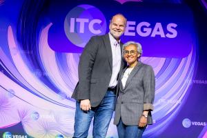 Grace Hanson, founder and CEO of Elysian, with Marcus Rohlfs, Silicon Valley Technology Scouting Leader at State Farm Ventures, on stage at ITC Vegas after Elysian’s winning pitch in the 2025 State Farm Startup Pitch Competition.