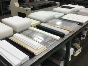 Assorted machinable plastic sheet, rod, and tube stock ready for CNC routing.