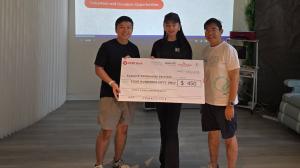 Kerry Guo presenting donation check to Epworth Community Services representative at Step Up for Empowerment Pilot Walk, Singapore