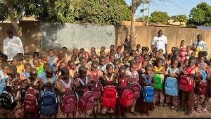 Young students in Burkina Faso receiving supplies for school.