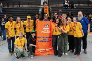 GSSM’s Golden Dragons Robotics Team holds the Inspire Award trophy after being recognized at the South Carolina FIRST Tech Challenge State Championship.