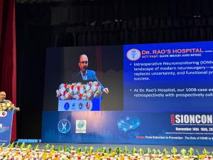 Dr. Mohana Rao Patibandla speaking at SIONCON 2025 at NIMHANS Bengaluru, presenting findings from his 1008-case intraoperative neuromonitoring study as a large slide on the screen highlights the summary points.