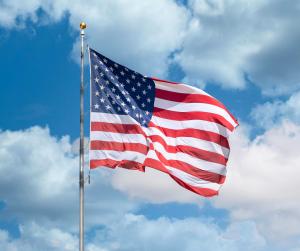 US Flag Flying in Clear Blue Sky