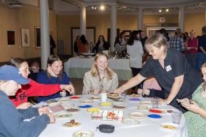 Students enjoy friendship bracelet making and refreshments during the opening event.