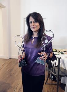 Nazeera holding the awards