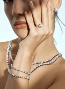 An image of a woman wearing a ring, bracelet, necklace, and earrings from Diamond Wish... the exceptional craftsmanship that has made Diamond Wish a cherished name in fine jewelry for over 4 decades.