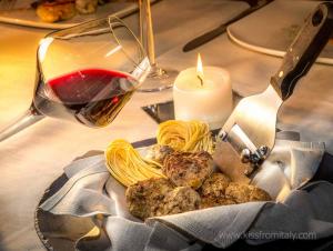 Glass of Barolo Red Wine and White Truffles, iconic wine and food of the Langhe region