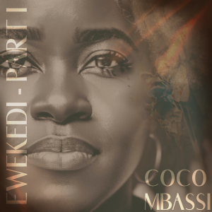 Close-up portrait of a Black woman’s face in warm brown and gold tones, shown from forehead to chin with detailed eyes, nose, and lips. The left side features the vertical text “EWEKEDI – PART I” and the bottom right shows the name “COCO MBASSI". Soft abs